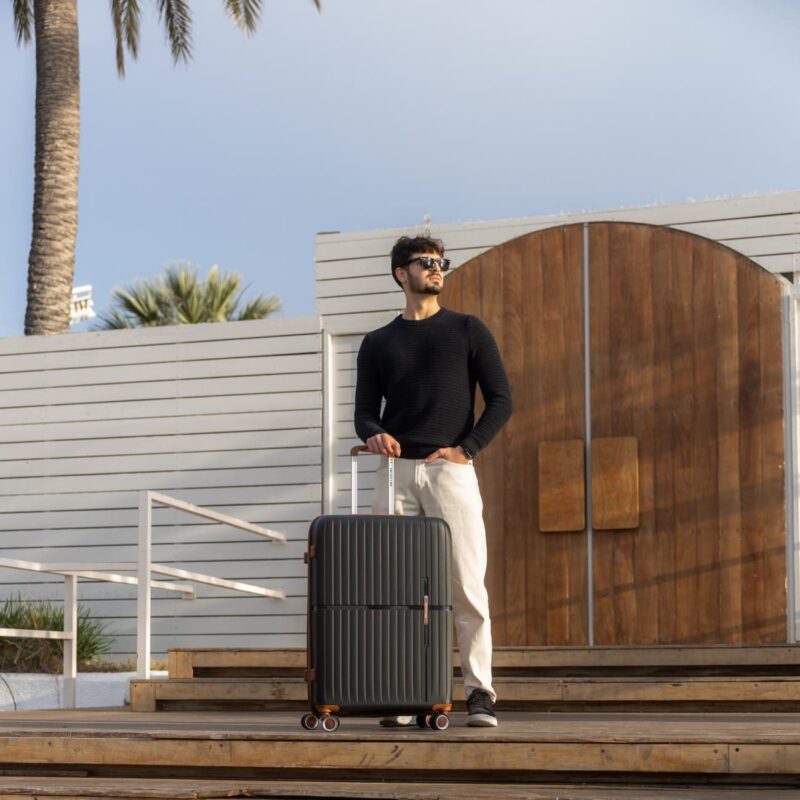 Βαλίτσα σκληρή μεγάλη Newcom (PP) N1596/70 μαύρο με μοντέλο να την κρατάει